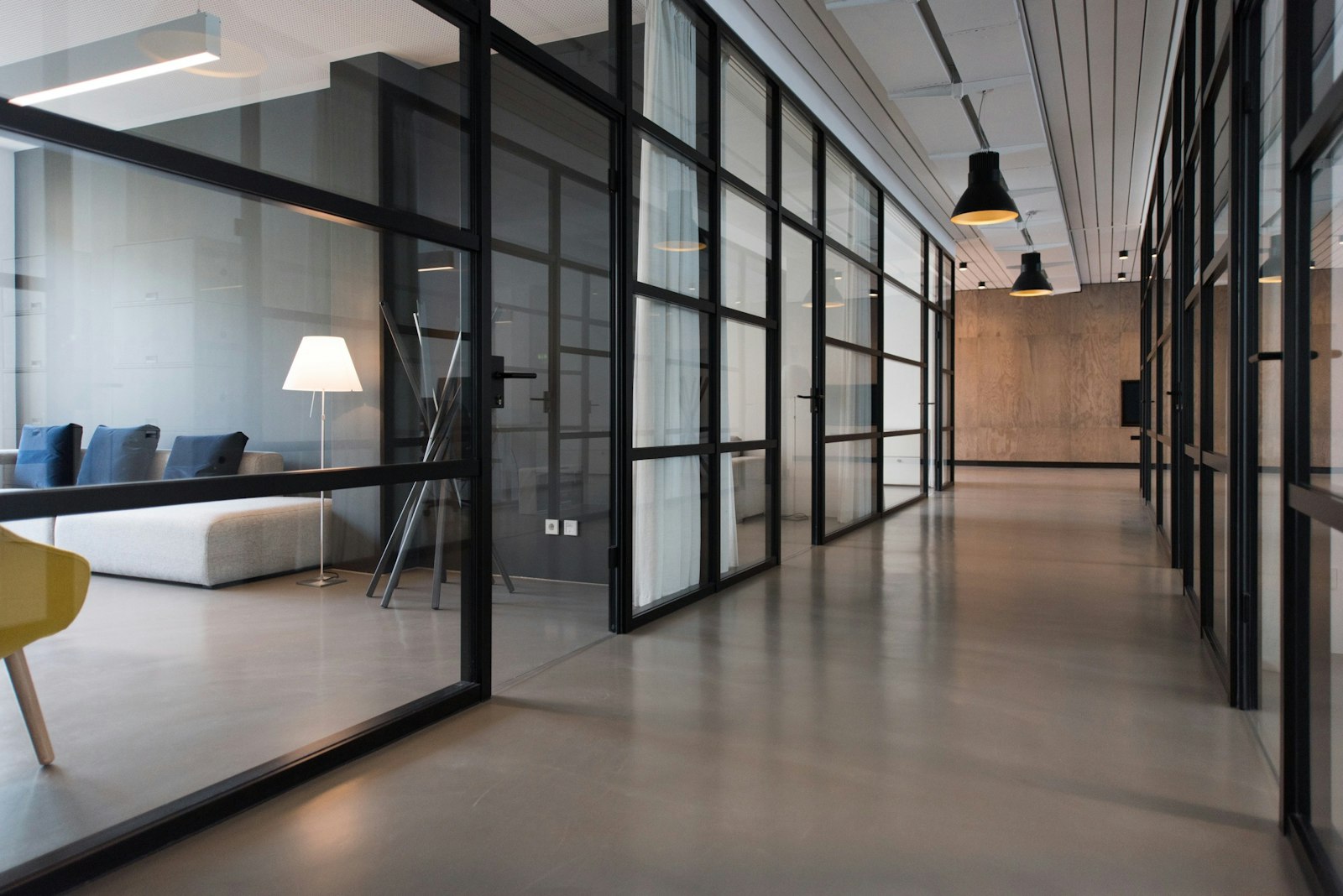 Modern office hallway with glass partitions