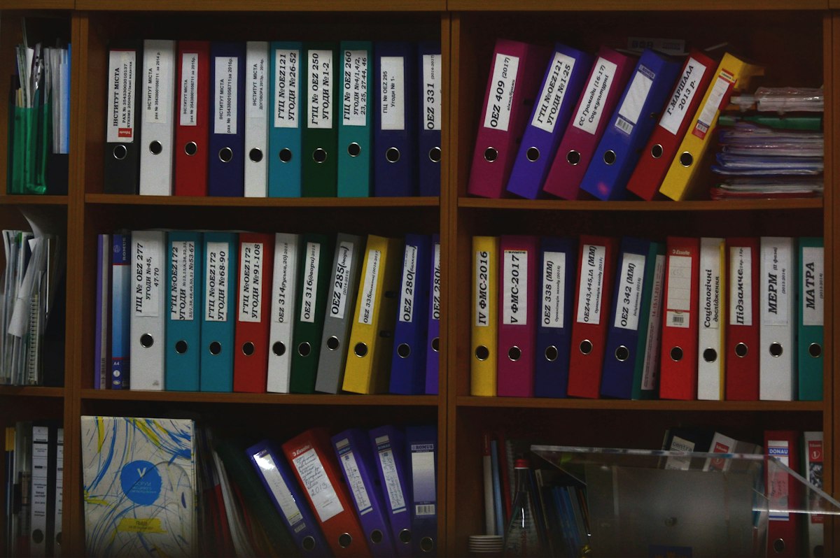 Organized office binders on shelves